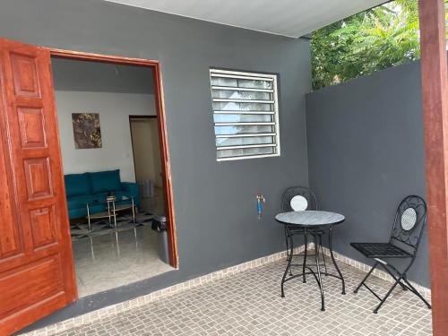 a room with a table and chairs and a door at Appartement cosy in Matoury