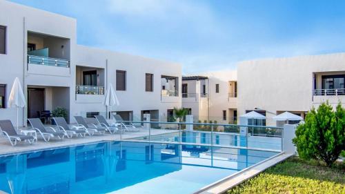 an image of a swimming pool in front of a building at Carisa Suites and Apartments in Maleme