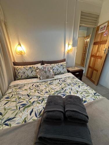 a large bed in a bedroom with two pillows on it at Bagley Terrace 136 Cottage in Johannesburg