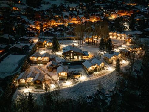 a group of houses in the snow at night at MAD Retreat Hotel in Nendaz