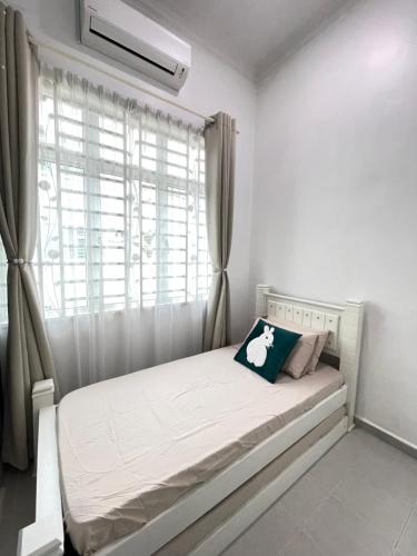 a white bed in a room with a window at La Vista Villa Private Pool in Kampong Gong Badak