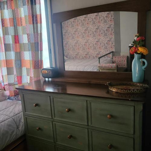 a dresser with a mirror on top of it at Gwangnam Beach Donabine in Busan