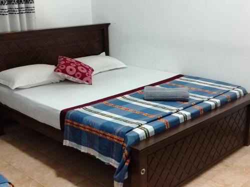 a bed with two pillows on top of it at WR Family and Holiday Resort in Anuradhapura