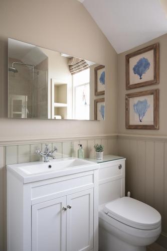 a bathroom with a sink and a toilet and a mirror at Turret House in Crail