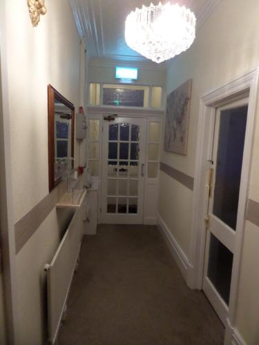 a bathroom with a sink and a chandelier at Nathans in Blackpool
