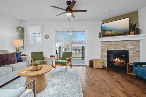 a living room with a couch and a fireplace at NEW Ivy House 3BR Townhome Downtown Beaches Wineries in Traverse City