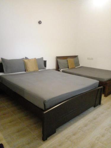 two beds sitting next to each other in a room at Winter Rest Villa in Nuwara Eliya