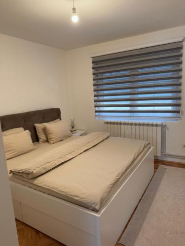 a large bed in a bedroom with a window at Luxury 2 Apartment in Bijelo Polje