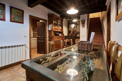 a kitchen with a glass counter top in a room at El Capricho del Jerte in Casas del Castañar
