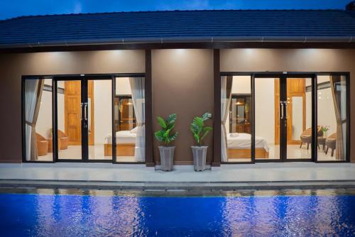 a house with a pool in front of it at MeyGun House in Lovina