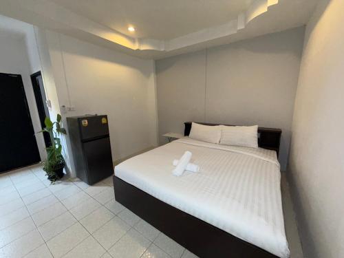a bedroom with a bed with a candle on it at Patong Canal Villa 101 in Patong Beach