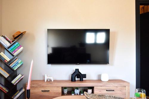 a living room with a flat screen tv on a wall at Politis Luxury Home in Lamía