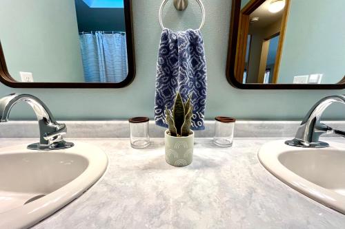 a bathroom with two sinks and a potted plant at Valley View Home with Game Room, & Exclusive Beach & Pool Access in New Rome