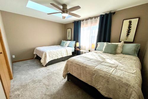 a bedroom with two beds and a ceiling fan at Valley View Home with Game Room, & Exclusive Beach & Pool Access in New Rome