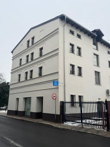 a white building on the side of a street at Apartament Centro 10 in Leszno