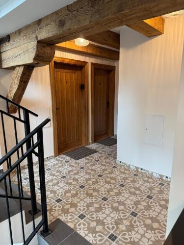 a hallway with a tile floor and wooden ceiling at Apartament Centro 10 in Leszno