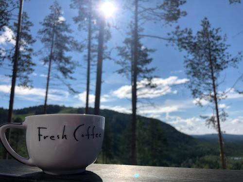 a coffee cup sitting on a table with a view at Storklinten 119 in Boden