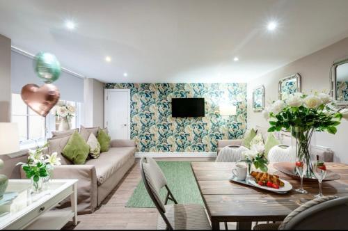 a living room with a couch and a table at Elysium Liverpool in Liverpool