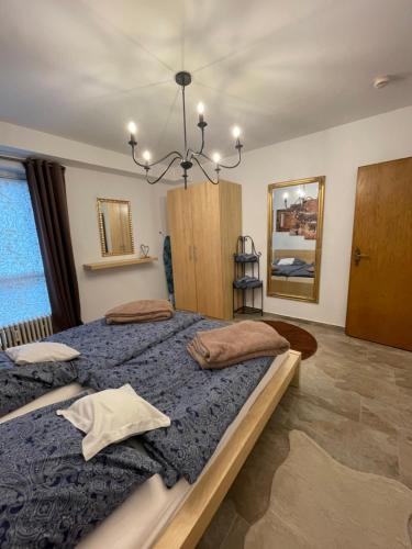 a bedroom with two beds and a chandelier at Köln Apartment I in Cologne