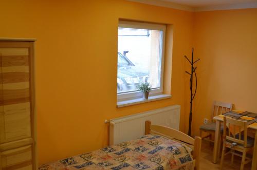um quarto com uma cama, uma janela e uma mesa em Apartment Sučany em Sučany