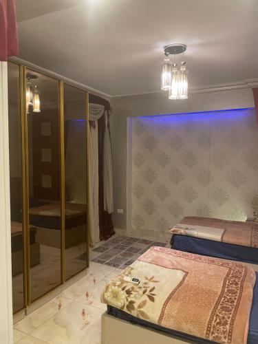 a bedroom with a bed and a walk in shower at Luxury 3 bedrooms apartment for rent in a sheikh zayed compound in Kafr Abū ʼumaydah