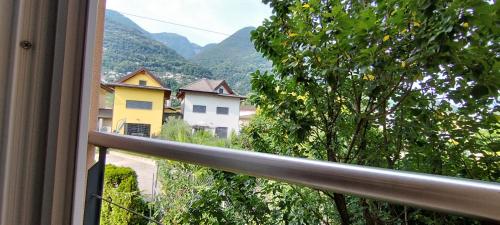 a view from a window of a balcony with mountains at Casa Diana Ticino in Cugnasco