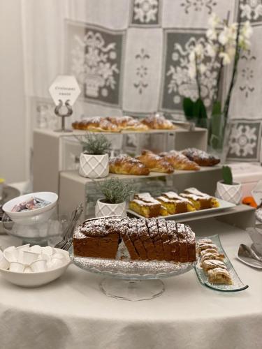 a table with different types of pastries and cakes at Boutique Hotel San Giovanni in San Giovanni in Persiceto