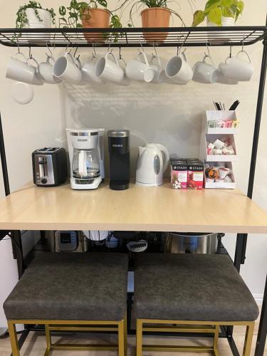 a shelf with cups and coffee cups on it at Family Fun! 5 King Beds-Hot Tub-Fire Pit-Ski-Hike in Sandy