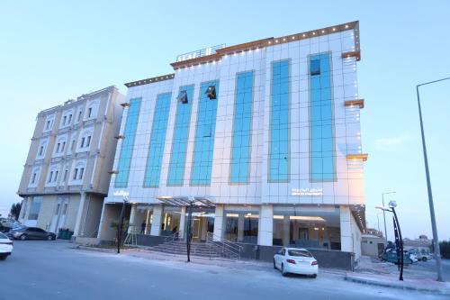 a large building with cars parked in front of it at افال للشقق المخدومة-اليرموك in Riyadh