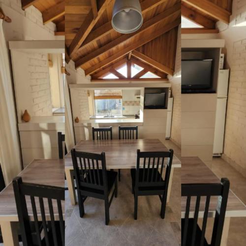 a dining room with a wooden table and chairs at Rincon del Sur in Esquel