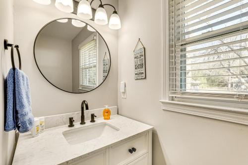 a bathroom with a sink and a mirror at Conveniently Located North Charleston Home! in Charleston