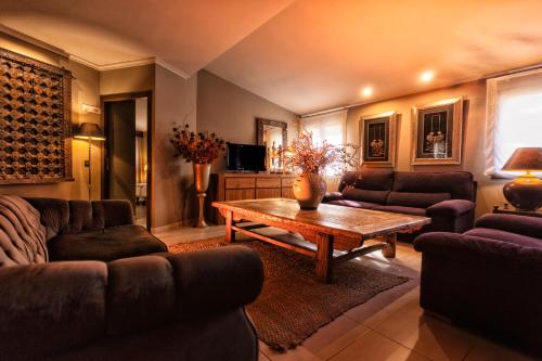 a living room with couches and a coffee table at SWISS MORAIRA HOTEL & SPA - Adults only in Moraira