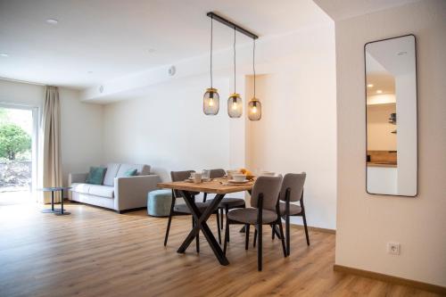 a dining room and living room with a table and chairs at Das Steinach in Pfronten