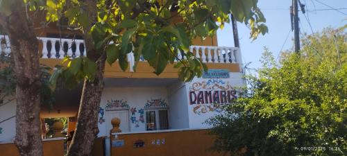 a building with a sign on the side of it at Damaris Hostel in Puerto Iguazú