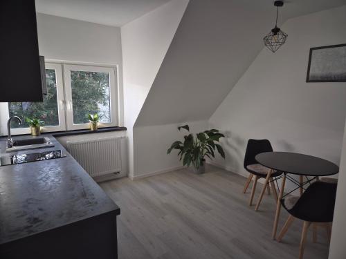 a kitchen with a table and chairs in a room at Soester Penthouse Apartement in Soest