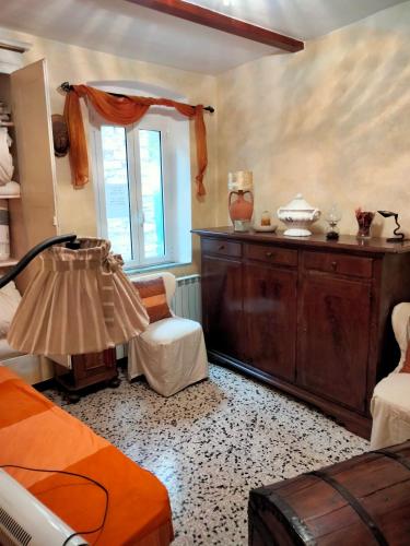 a bedroom with a bed and a dresser and a window at Casa Mami in Isolalunga