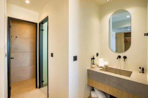 a bathroom with a sink and a mirror at Thalassa Suites in Afiartis