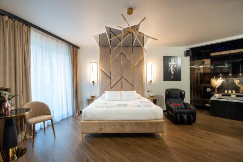 a bedroom with a king sized bed and a chair at Apartament z jacuzzi, Wiślane Tarasy in Krakow