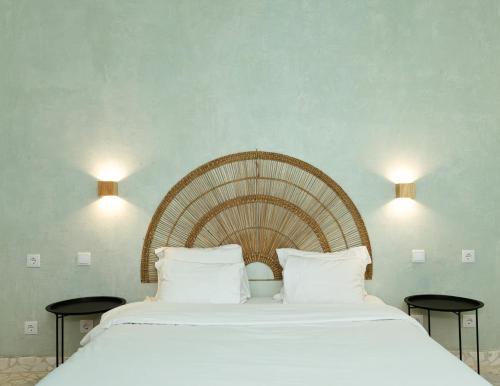 a bedroom with a large bed with white sheets at Sintra Lagon in Sintra