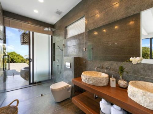 a bathroom with two sinks and a toilet at Amazing Luxury Villa in Ban Thung