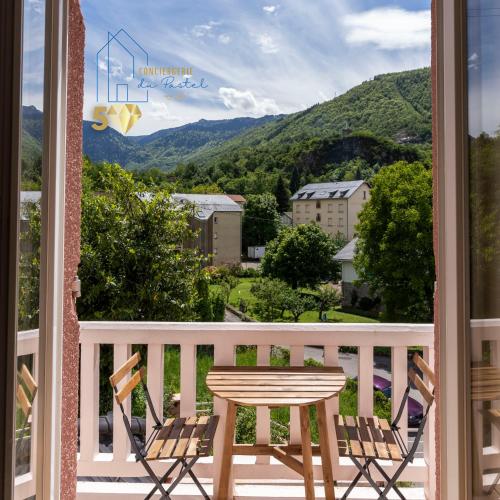 a table and chairs on a balcony with a view at Le Grillon de Pongo Elegant T2 avec balcons in Ax-les-Thermes