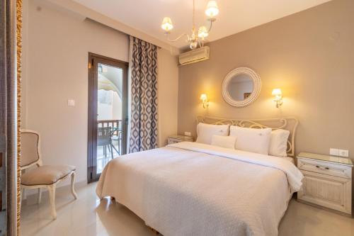 a bedroom with a bed and a chair and a window at kassandrinos apartments apostolos in Nikiti