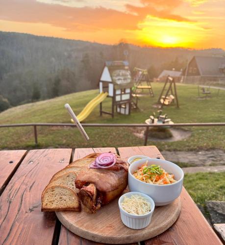 a plate of food with a piece of bread and a sandwich at Resort Mezná in Hřensko