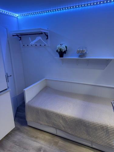a bedroom with a bed with blue lights on the wall at Apartment with terrace Nasinge 4F in Strömstad