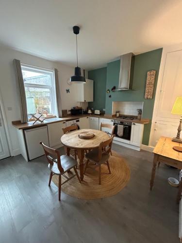 a kitchen with a table and chairs in a room at Country File in York