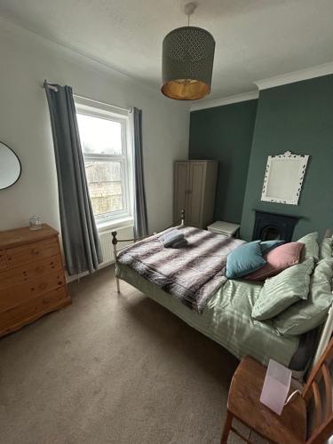 a bedroom with a bed and a window at Country File in York