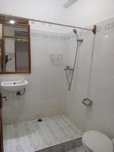 a bathroom with a toilet and a sink at Mimpi Bungalow 3A in Kubutambahan