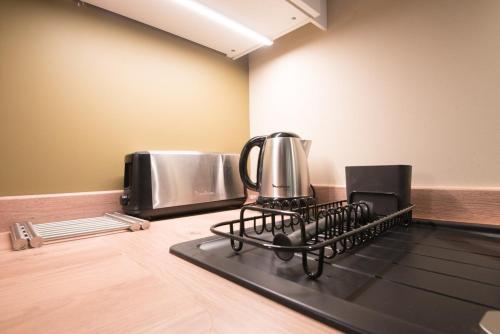 a kitchen with a coffee maker on a stove at le petit logis in Trélazé