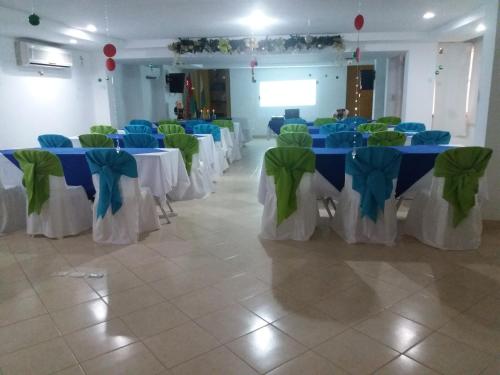 a room with blue and green tables and chairs at Hotel Tumburagua Soin Sas in Neiva