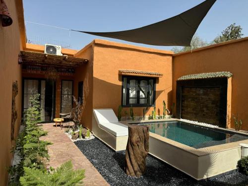 a house with a swimming pool in the yard at Cozy, Intimate Villa in Marrakech with Heated Swimming Pool Option in Touggana